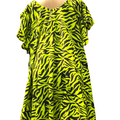 Neon green and black zebra pattern dress on a mannequin against a white background