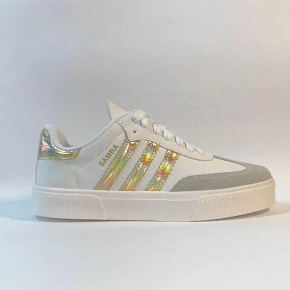 White sneaker with holographic stripes on a light gray background