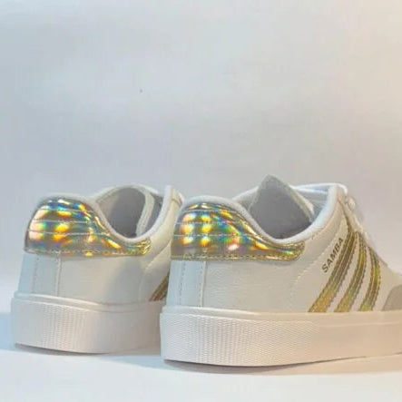 White sneakers with gold accents on a white background