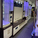 Display of electronic equipment in a showroom with purple lighting
