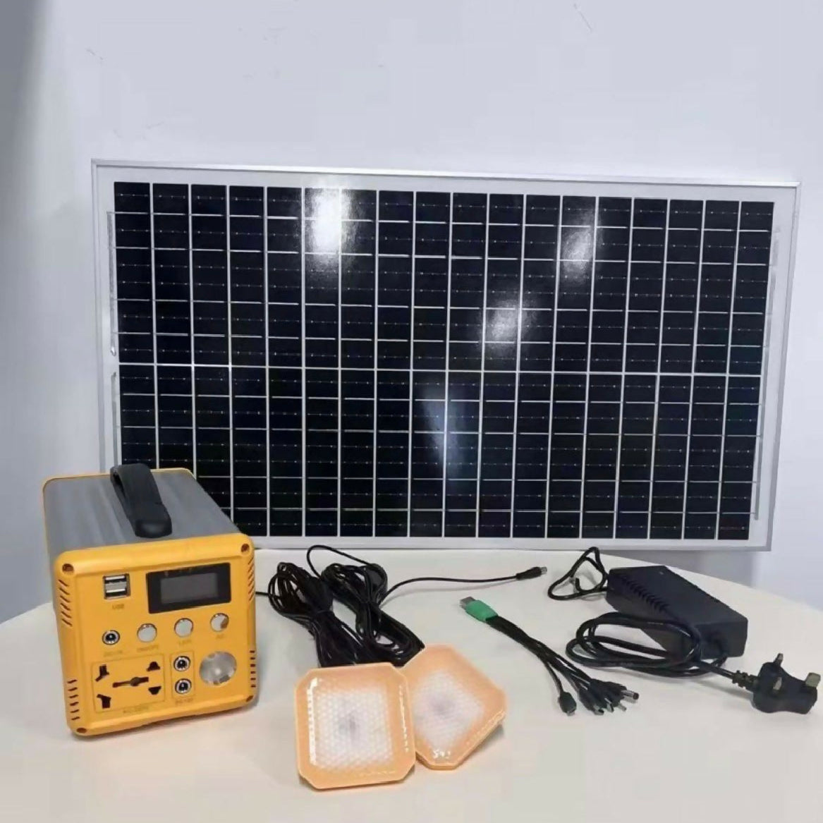 Solar panel, battery pack, and lights on a white surface
