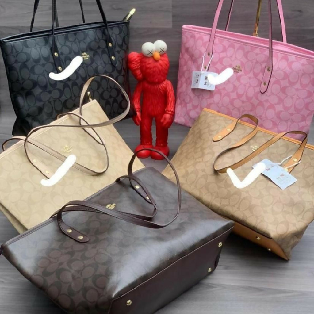 Collection of handbags on a wooden surface with a red figurine in the center.