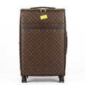 Brown suitcase with monogram pattern on a white background