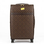 Brown suitcase with monogram pattern on a white background