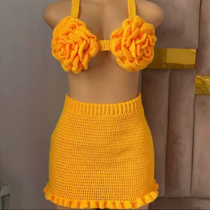 Yellow crochet bikini set on a mannequin against a neutral background