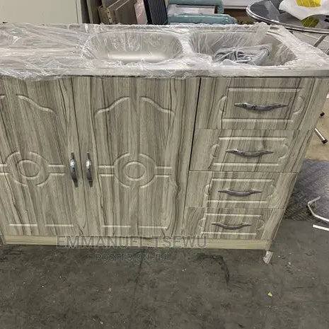 Wooden cabinet with sink and drawers on a concrete floor