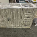 Wooden cabinet with sink and drawers on a concrete floor