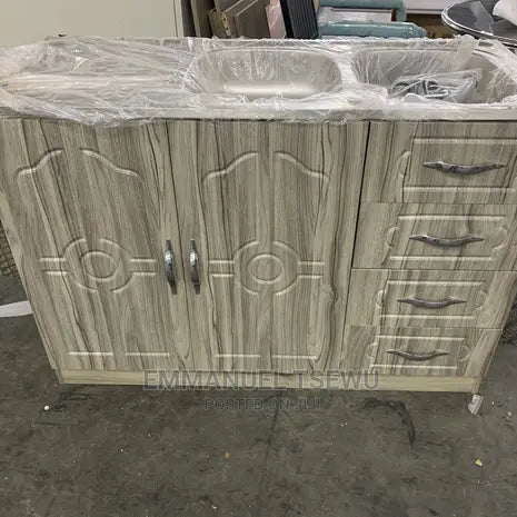Wooden cabinet with sink and drawers on a concrete floor