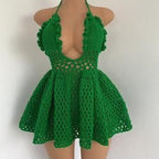 Green crochet dress on a mannequin against a white background