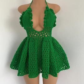 Green crochet dress on a mannequin against a white background