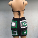 Mannequin wearing a black crochet top and shorts with geometric patterns on a gray background