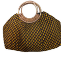 Yellow and black woven handbag with wooden handle on a white background