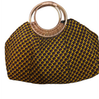 Yellow and black woven handbag with wooden handle on a white background