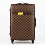 Brown checkered suitcase with a yellow label on a white background