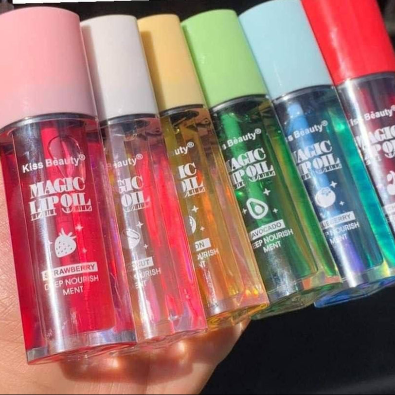 Set of colorful lip oil bottles held by a hand with text in the background.