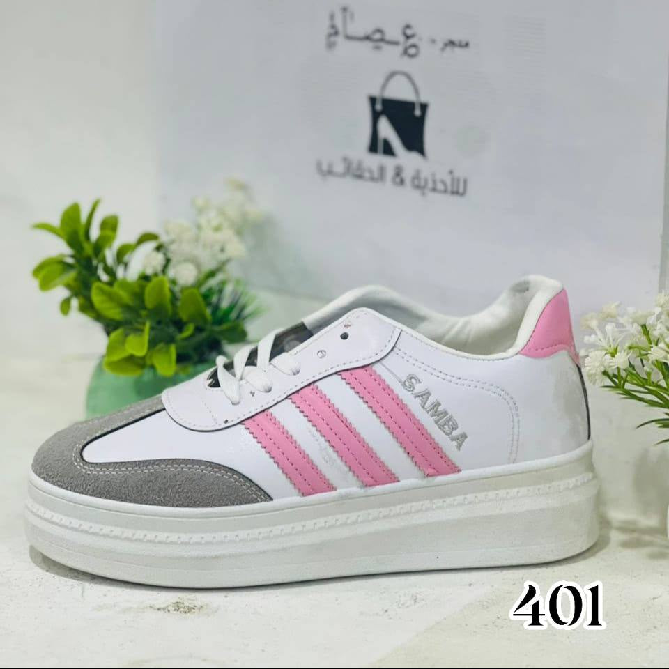 White and pink sneaker with gray sole on a white background