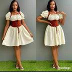 Woman wearing a white dress with red corset and suspenders on a grassy floor.