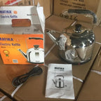 Matika electric kettle with packaging, cord, and manual on a cardboard surface