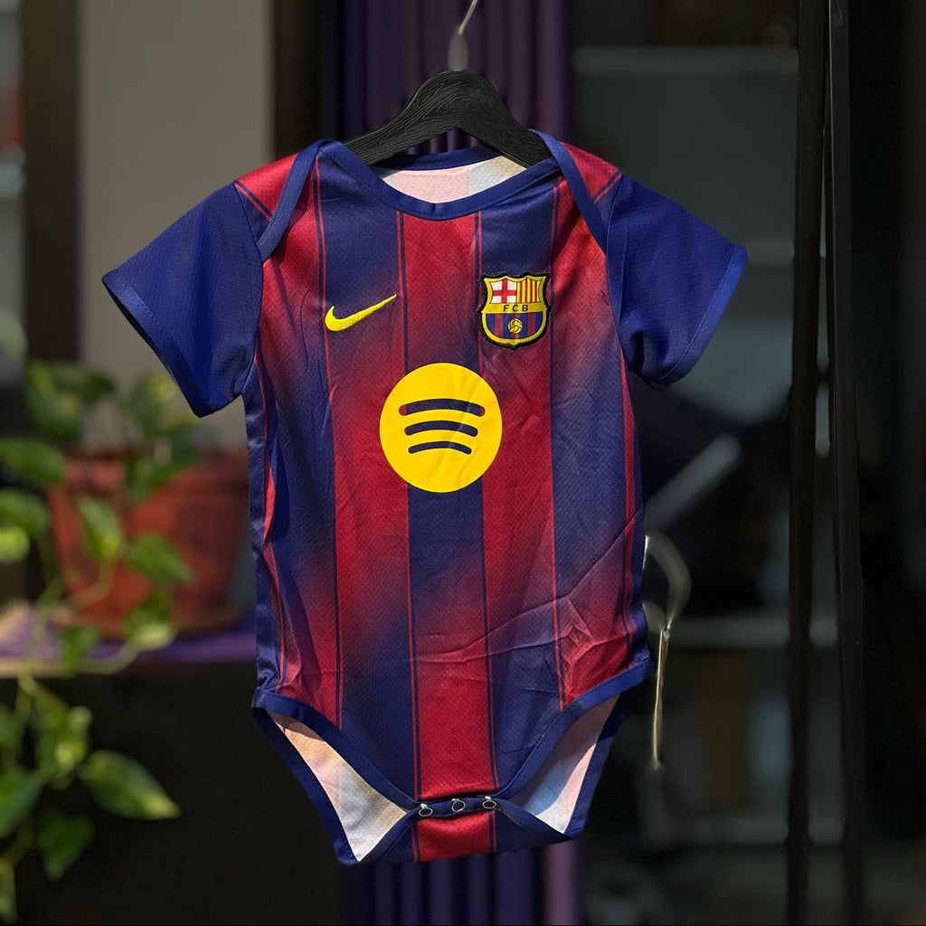 Children's sports jersey with a logo on a hanger against a blurred background