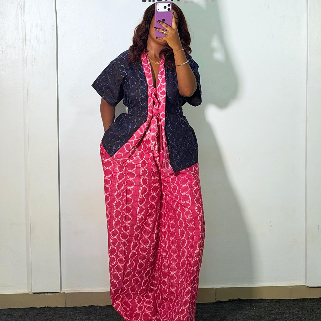 Person wearing a pink and navy outfit in front of a white wall with 'Amira' branding.