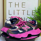 Pink and navy sneakers on a stand with a sign in the background