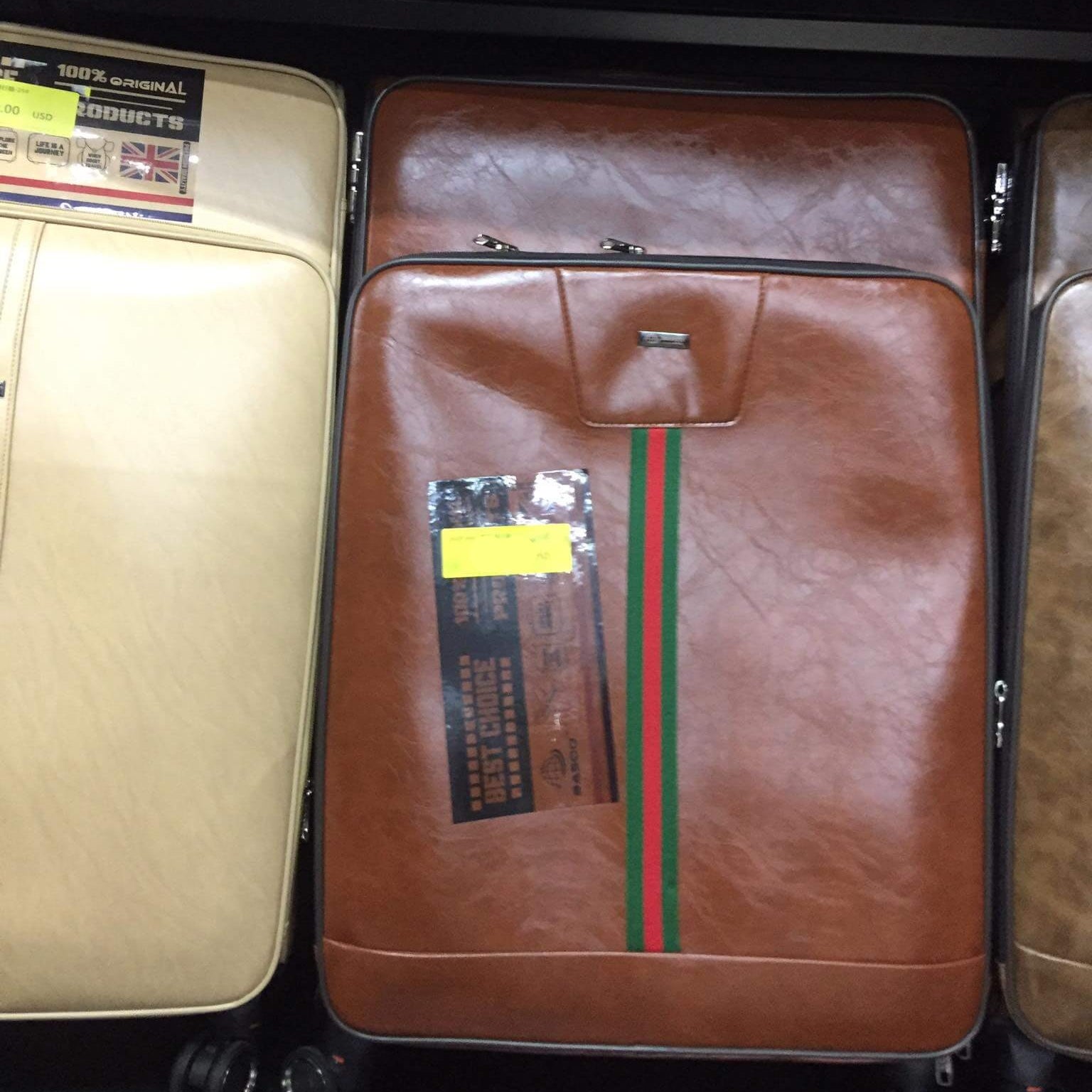 Brown suitcase with visible brand label on a black surface