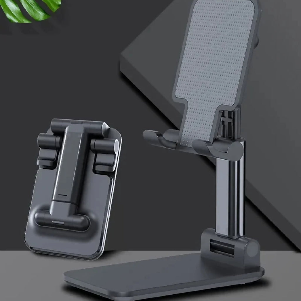 Two adjustable phone stands on a dark surface with a leaf in the corner.