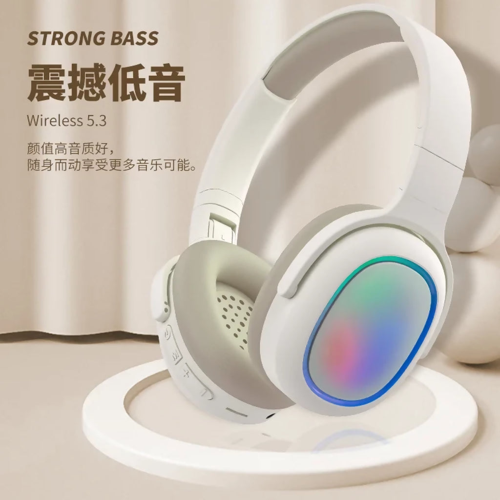 White headphones with colorful LED display on a beige background, featuring text about strong bass and wireless 5.3 technology.