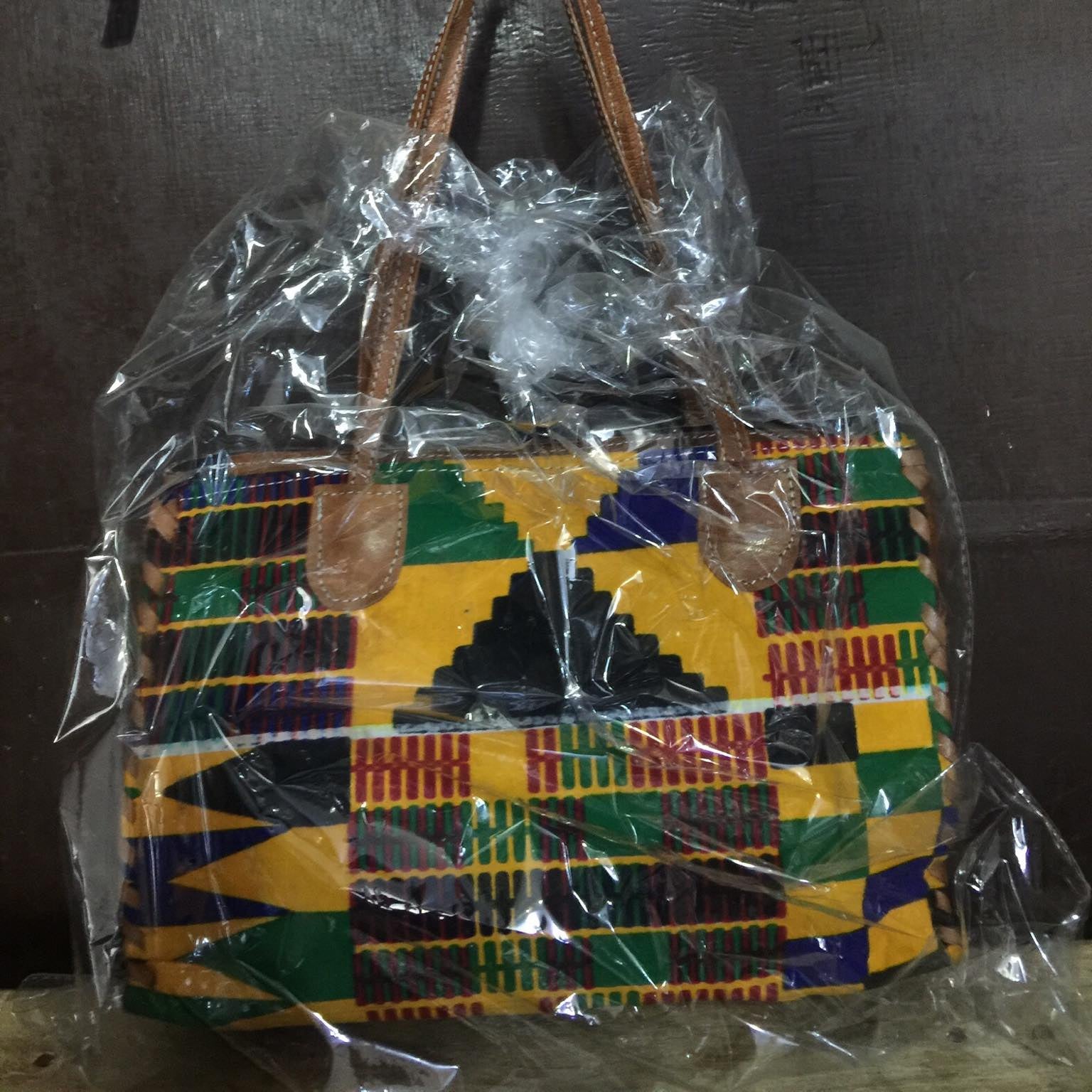 Colorful patterned bag wrapped in plastic with a colorful background