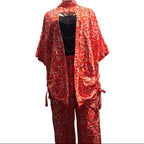 Red patterned outfit on a mannequin in front of a car