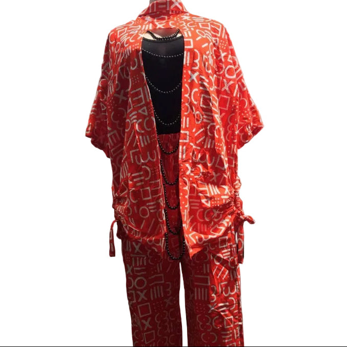 Red patterned outfit on a mannequin in front of a car