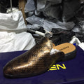 Gold glittery shoe on a blue surface with other shoes in the background.