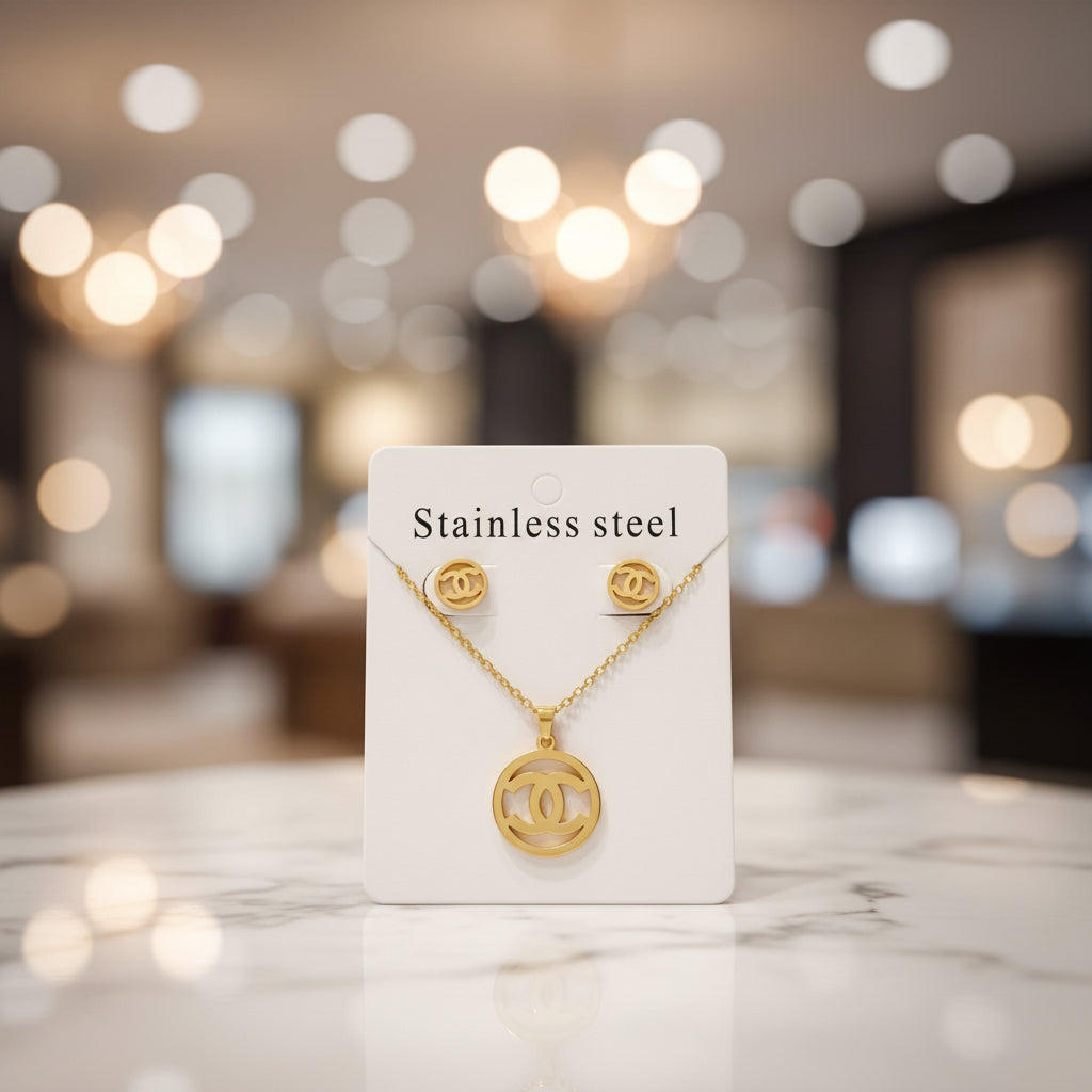 Gold necklace with a 'CC' logo on a white card labeled 'Stainless steel'.