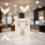 Gold necklace with a 'CC' logo on a white card labeled 'Stainless steel'.