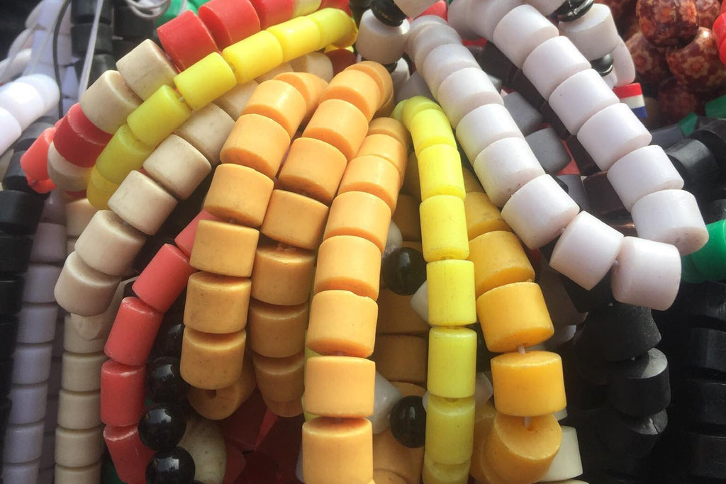 Colorful beaded bracelets on a wooden surface with a blurred background