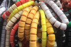 Colorful beaded bracelets on a wooden surface with a blurred background