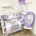 Baby crib set with purple and gray elephant design in a nursery.