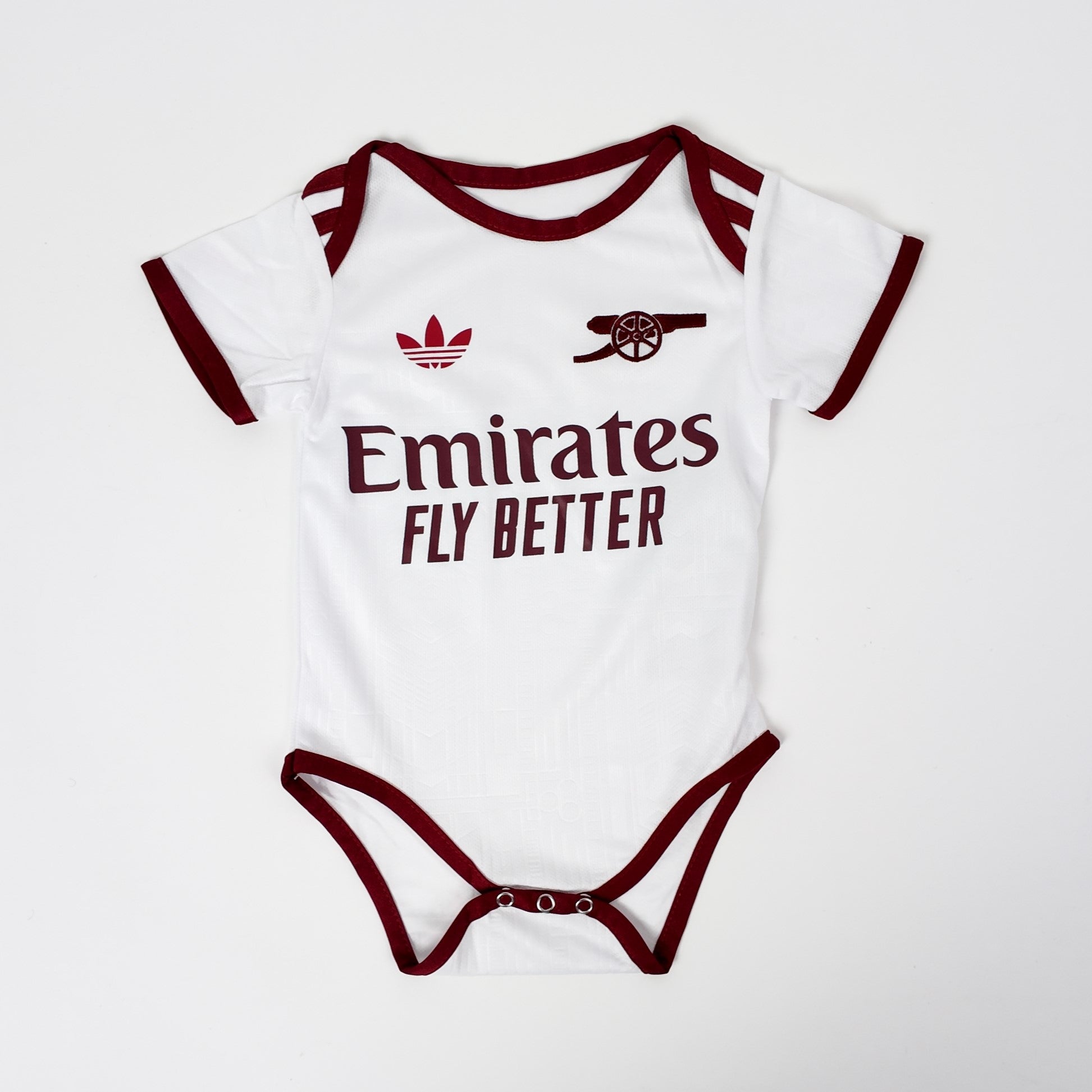 Baby onesie with Emirates branding on a white background
