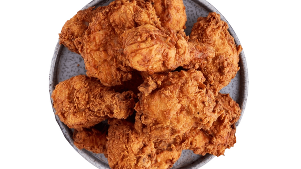 Fried chicken pieces on a white background. Fried chicken thighs from Town Bakery