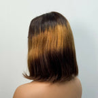 Back view of a person with a shoulder-length hair cut on a plain background