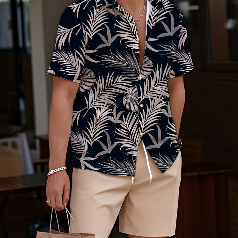 Man wearing a navy and white leaf-patterned shirt with beige shorts, holding a brown paper bag.