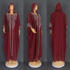 Maroon abaya with silver embroidery on a gray background