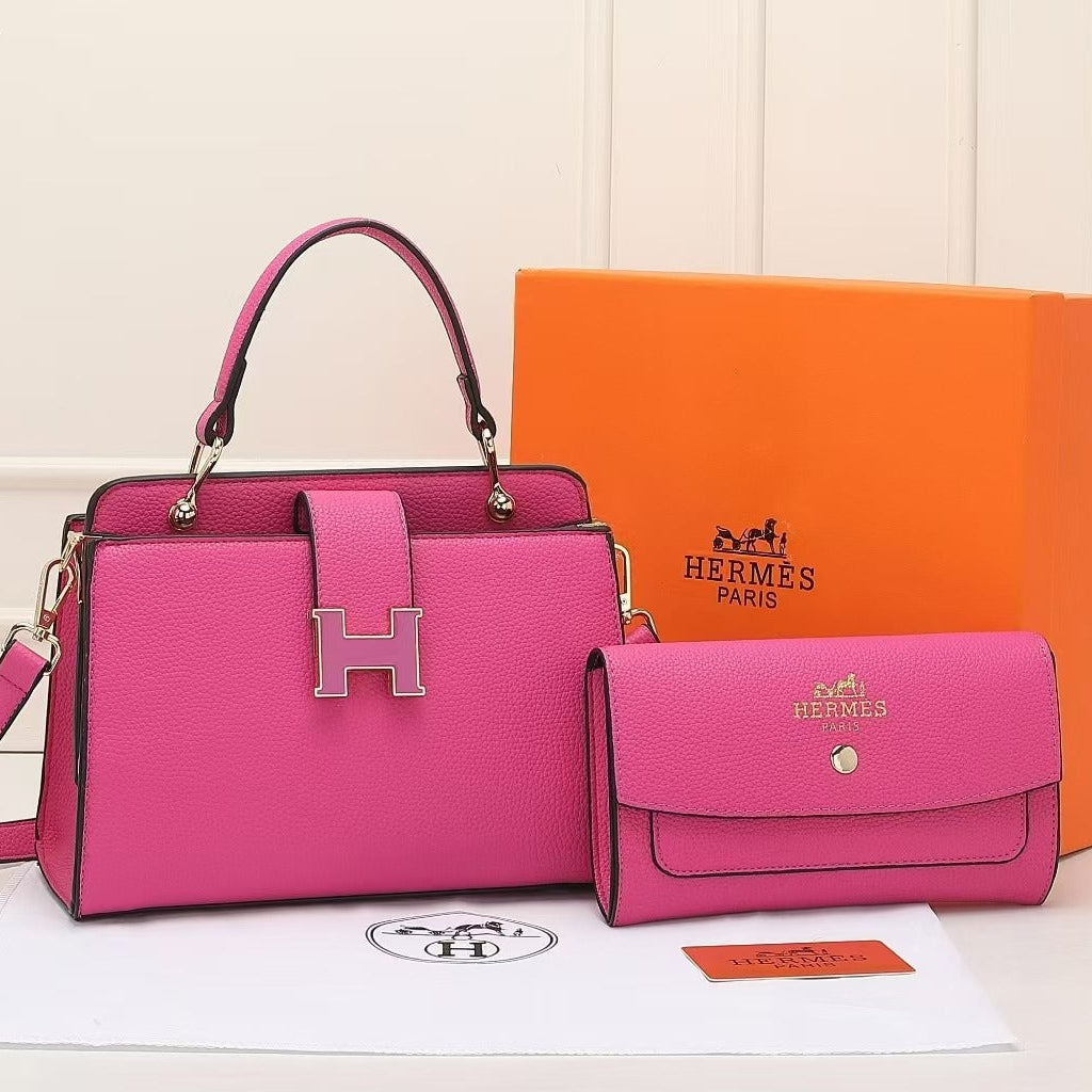 Pink Hermes handbag and matching wallet with orange Hermes box on a light background