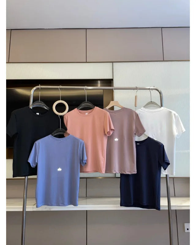 Collection of colorful t-shirts on hangers against a kitchen background