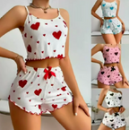 A collage showing a women's two-piece pajama set worn by a model, with four smaller color variants on the right. The main set is white with red heart prints and a red bow at the waist.