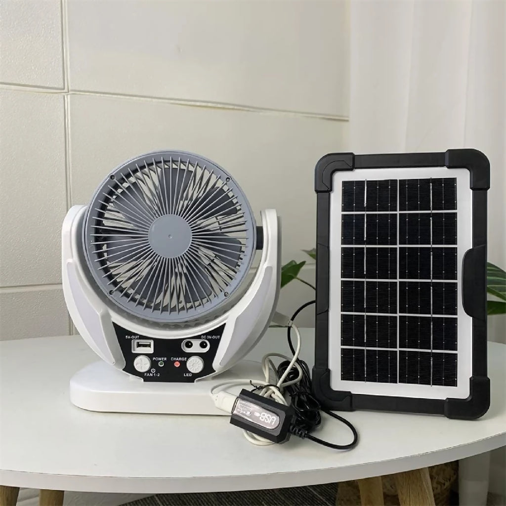Portable fan with solar panel on a white surface