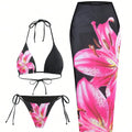 Black bikini set with pink floral design and matching skirt on a white background