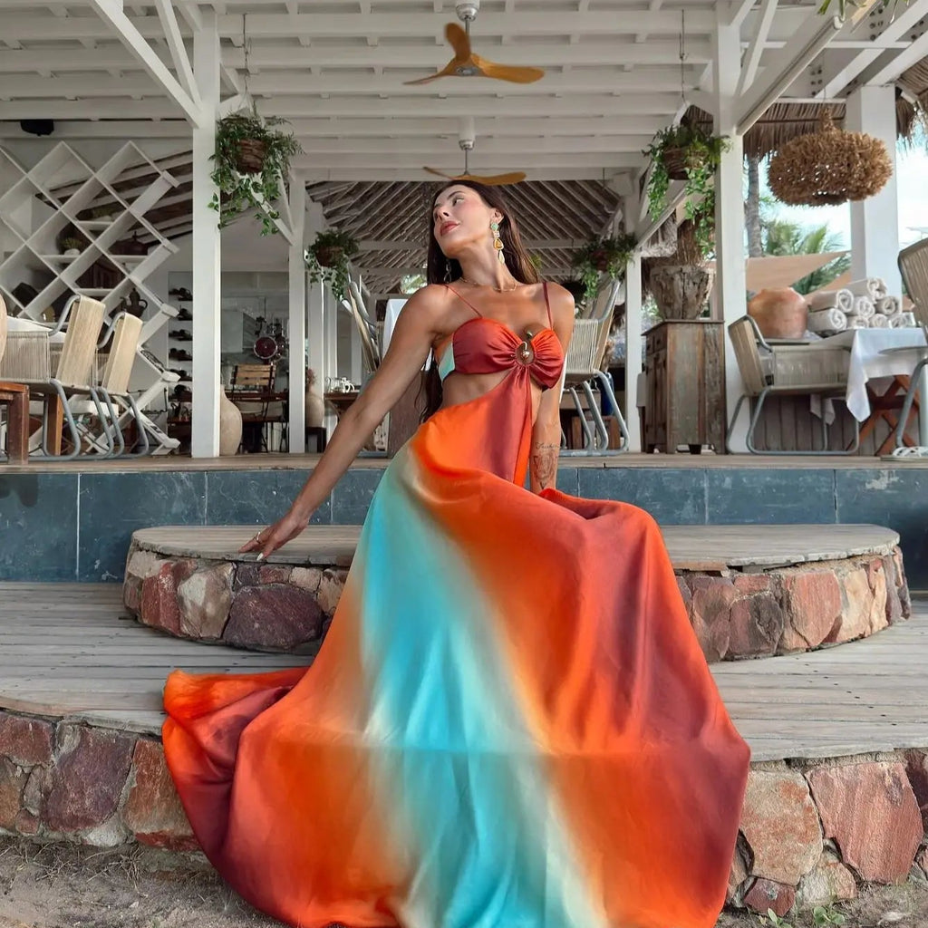 Woman in a colorful dress sitting on stone steps in a tropical setting