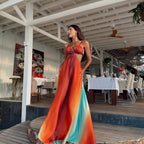 Woman in a colorful dress standing in a restaurant setting