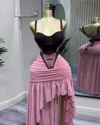 Mannequin wearing a black top and pink skirt with a blurred background